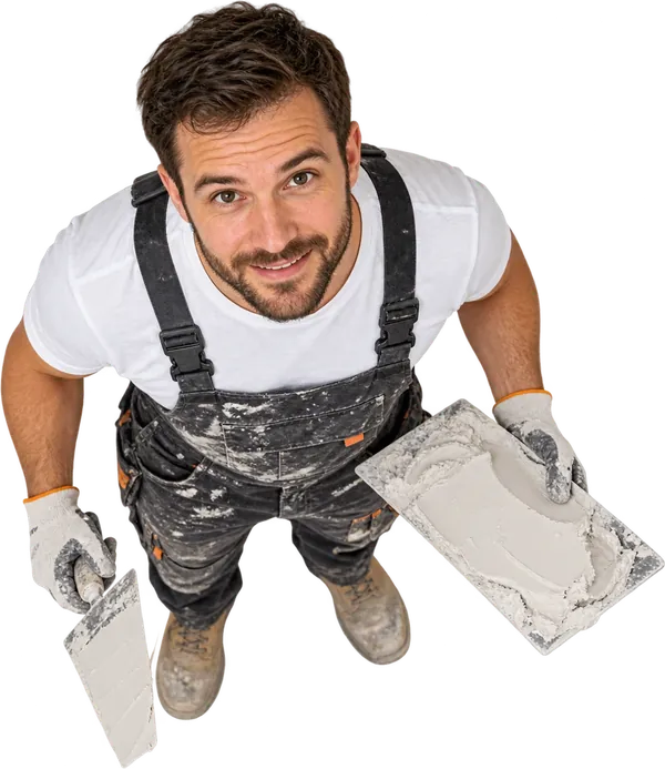 Smiling plasterer in work overalls holding a trowel and a hawk of fresh plaster